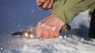 Striking fire with a knife and flint