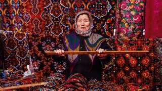 Weaver in Marguilan silk market Uzbekistan