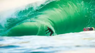 Surfer coming through a piping wave in Rileys, Ireland