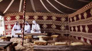 Three men in a traditional tent in Dubai