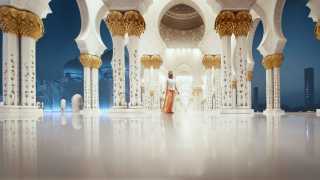 Woman looking at Sheikh Zayed Grand Mosque in Abu Dhabi, UAE