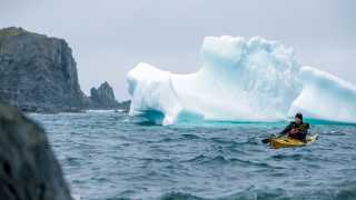 Kayaking past icebergs in Canada