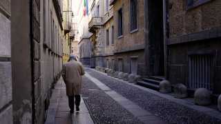 A man walking through Milan in the winter