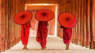 People walking with umbrellas in Myanmar