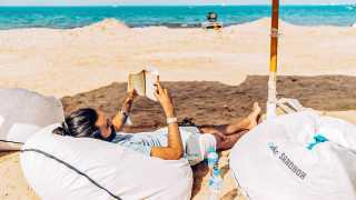 Reading book on beach