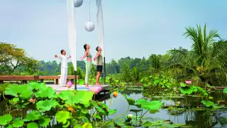 Yoga by the lotus pond at Four Seasons Sayan