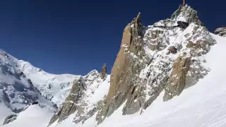 Snow resembling icing sugar below a rock formation in Vallee Blanche, Chamonix