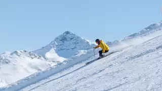 A skier glides down the mountain
