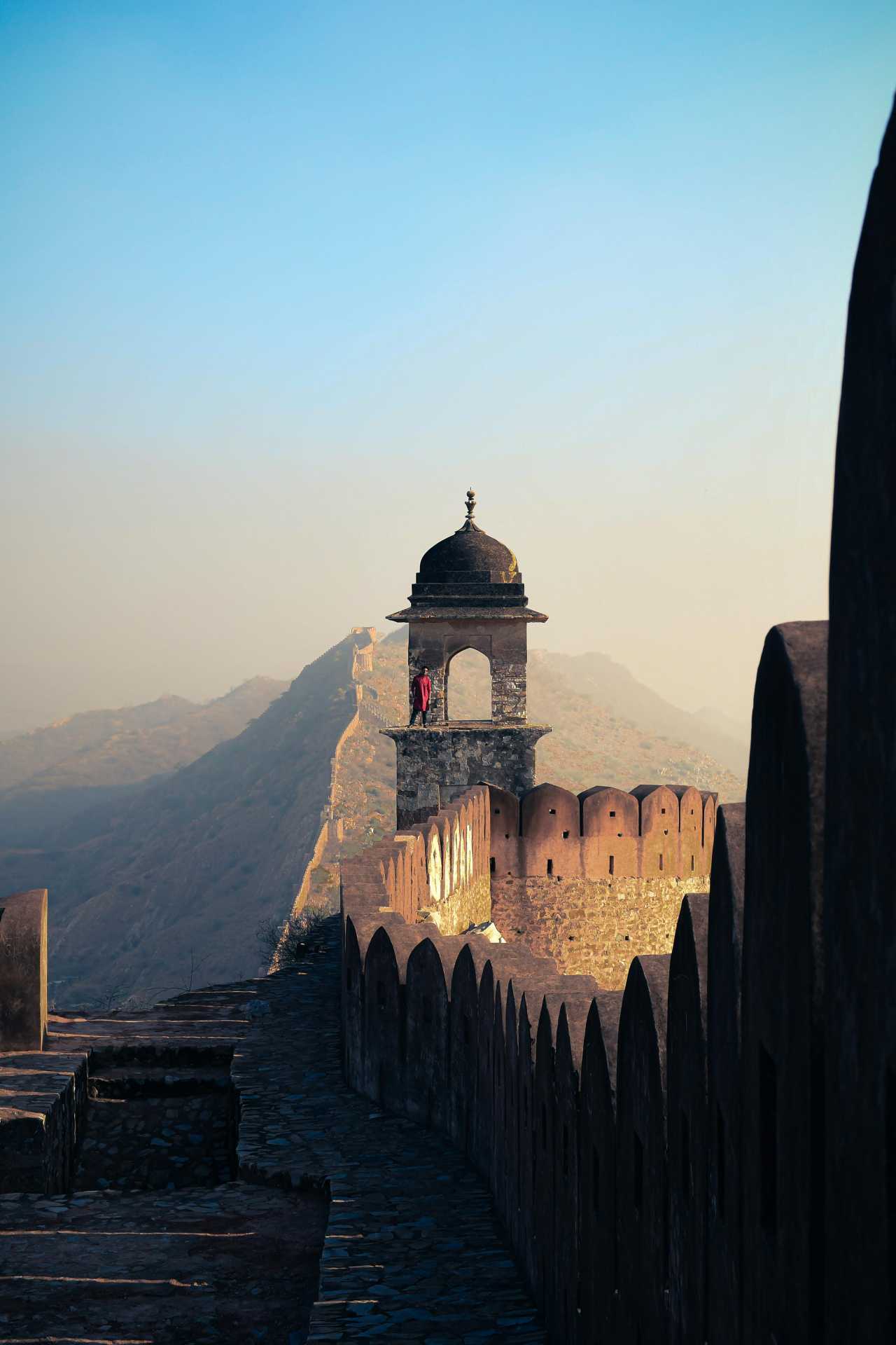 A man stands on the fortified embattlements of the Amber Palace in Rajasthan