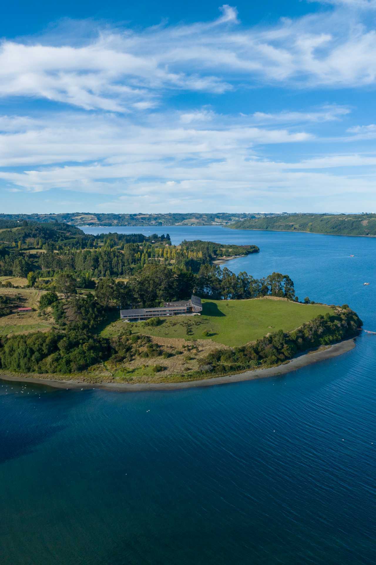 An aerial shot of Refugia Chiloé hotel and lake