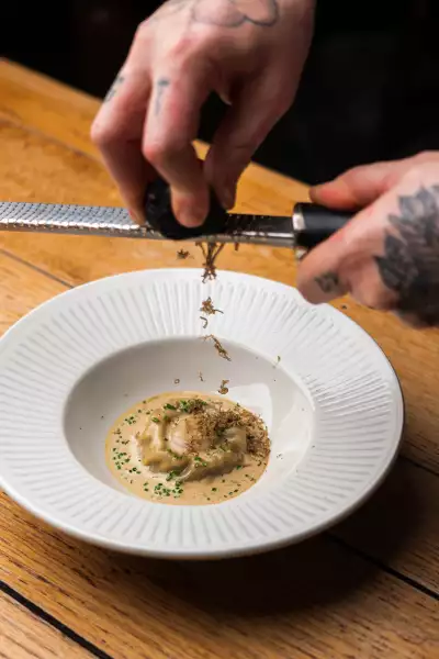 Wild mushroom and egg yolk raviolo with truffle