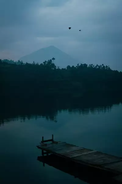 Under the towering slopes of Mount Muhavura lies the serene Lake Kayumba, an oasis of calm tucked away among the hills