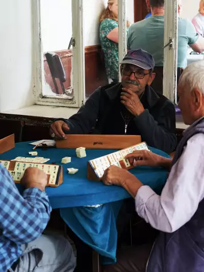 A man concentrates playing a game of okey in a village in Kasımlar