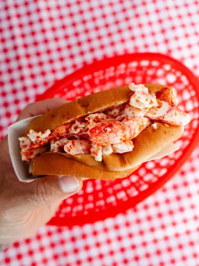 A freshly made lobster roll from Scarborough Lobster on Route 1, piled high with sweet Maine lobster and served in a soft, lightly toasted hot dog bun