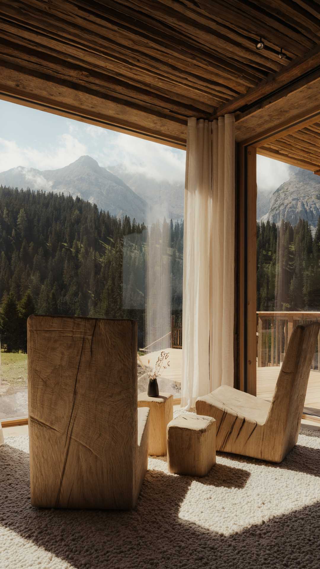 Two wooden seats look out onto the mountains