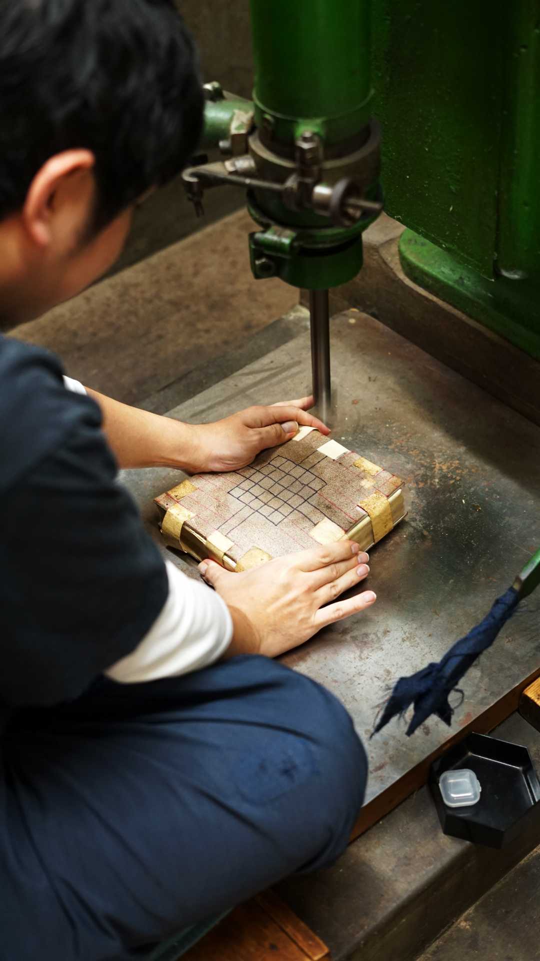 Hammering sheets of gold leaf