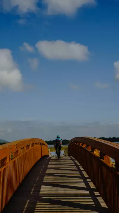 Biking along a steel bridge