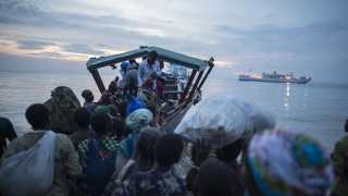 Refugees risking their lives travelling over seas in dangerously overcrowded boats