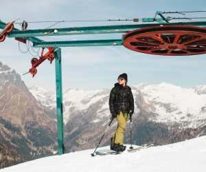 A splitboarder atop the abandoned chairlift in Gaver, Italy