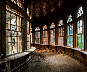 Curved interior bridge of abandoned American psychiatric hospital
