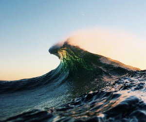 Wave breaking with sunrise glow