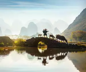 Farmer on bridge in Yangshuo, China