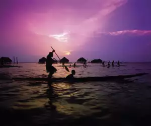 A canoe padler at sunset