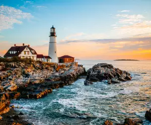 A summer sunrise at one of Maine’s most popular lighthouses, Portland Head Light in Cape Elizabeth